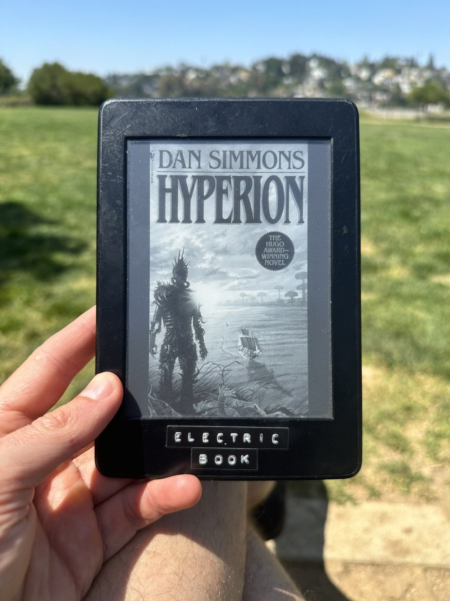 sitting in the meadow, reading the hugo award-winning novel, hyperion.
