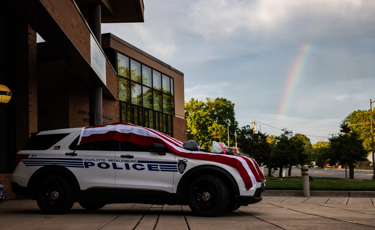 A rainbow appears to pour out over the memorial outside CMPD North Tryon Division where fallen Officer Joshua Eyer worked. <a href="/theobserver/">The Charlotte Observer</a>
