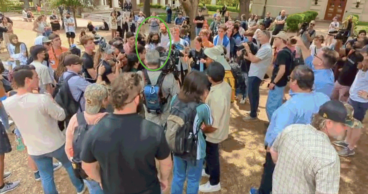 It is being reported someone with the Palestinian protestors at the UT sit down protest today had a sign with a swastika. At 33 minutes in to @DocumentingATX 's video you can see the person highlighted picks something off of the ground and goes to the right and proceeds to tear