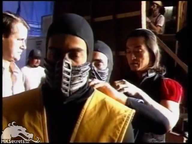 Shang Tsung (Cary-Hiroyuki Tagawa) fixes Sub-Zero's (François Petit) costume while he helps fixes Scorpion's (Chris Cassamassa) outfit before filming a scene for Mortal Kombat, 1995.