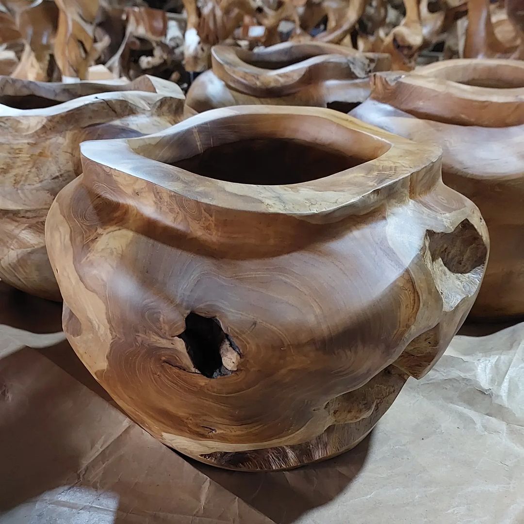 Teak Root Flower Vases Meticulously crafted from reclaimed teak roots. Each showcases a rich tapestry of knots & gnarls, making it a striking standalone piece. The natural flow of the root creates intricate patterns and holes, ideal for creating stunning dry flower arrangements.