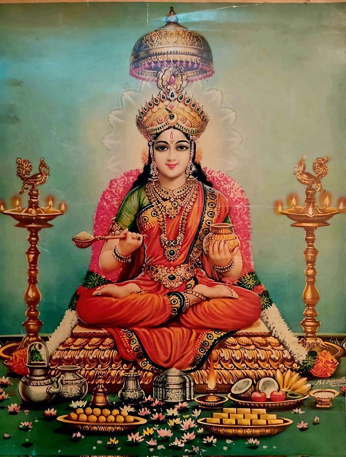 Annapoorneshwari Devi Devi who feeds the whole universe. She holds a golden ladle in one hand & a golden vessel filled with rice (Annam) in the other.