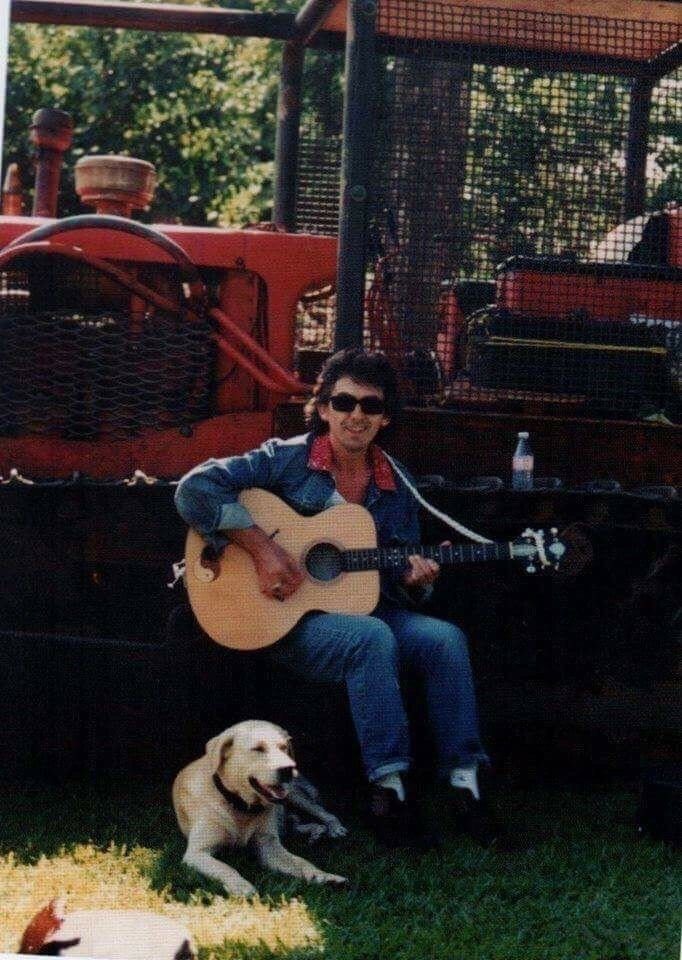 #GeorgeHarrison playing guitar with his dog in the 80s