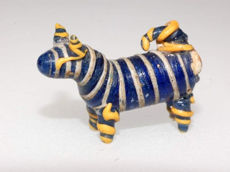The Wallertheim little dog is a notable archaeological find from Wallertheim, a municipality in Rhineland-Palatinate, Germany. This artifact, measuring 2.1 cm long and 1.6 cm broad, is made of blue glass covered with white threads. It was discovered as part of a collection of…