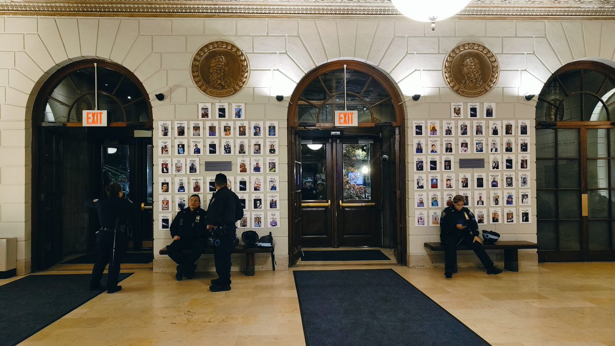 Behind these cops is a memorial wall we set up for the journalists killed in this war. The NYPD came into the journalism building at Columbia (where even outside press is not allowed at this time) to rest their legs and eat some snacks after a long night of arresting students.