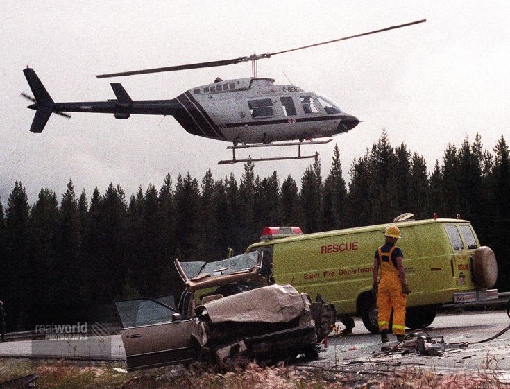 A lone firefighter watches as a helicopter departs with an injured occupant. Alberta, Canada. Gary Moore photo. Real World Photographs. #photojournalism #world #canada #firefighter #alberta #sweden #garymoorephotography #realworldphotographs #nikon #documentary #photography