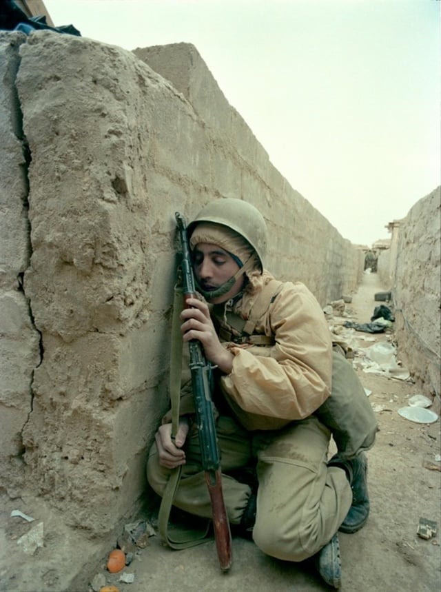 Iranian soldier asleep from fatigue during the Seige of Basra, the bloodiest battle of the Iran-Iraq War. March 1987.