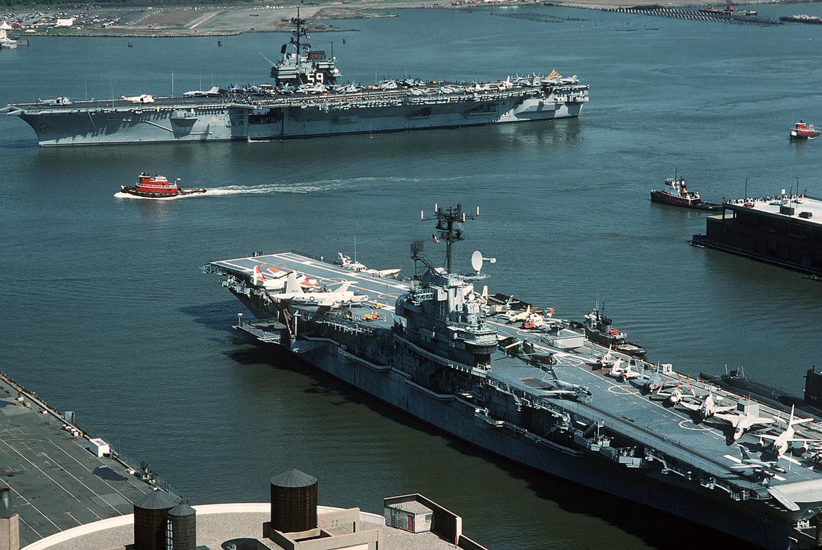 Boneyardsafari's tweet photo. #otd A tug boat accompanies USS Forrestal CV-59 as the ship departs New York City at the end of Fleet Week, May 1st 1989.  In the foreground is Intrepid CVS-11 Museum. #ussforrestal #cv59 #ussintrepid #cvs11 #cv11 #newyorkcity #navalsafari #aviationsafari #boneyardsafari https://t.co/2q6n9mbgTM