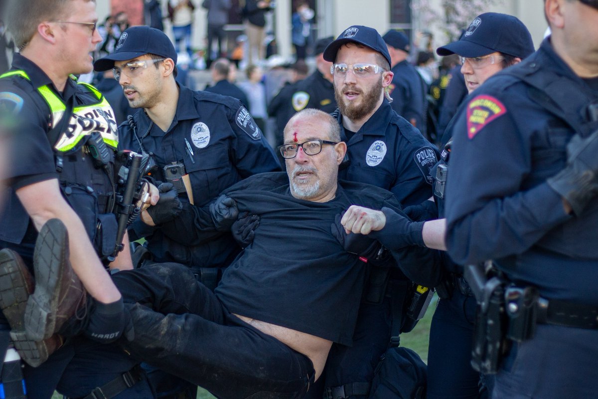 Take a look at this photo from @DWhiteBergey, who captured UW-Madison professor Samer Alatout being detained at this morning's pro-Palestine protest on Library Mall: