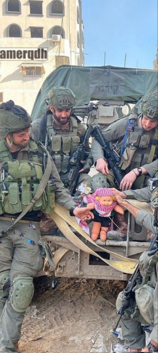 Israeli terrorists posing with toys they took from children they killed.