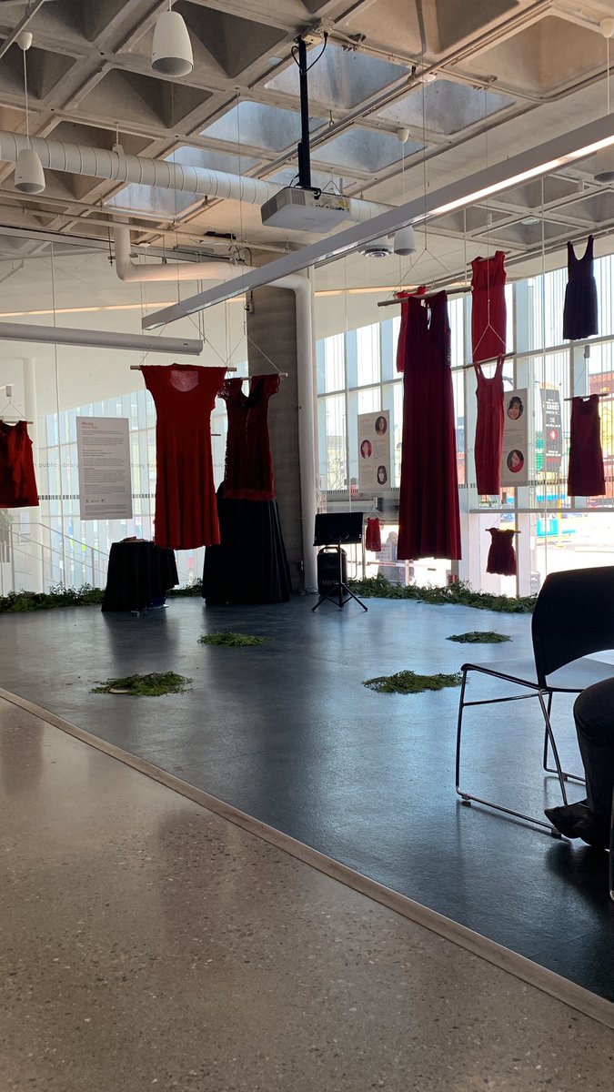 Red Dresses exhibit “Missing” opening at the Central @HamiltonLibrary The dresses are beautiful, hung with images & bios of stolen sisters. Cedar has been laid around the room and directly under 4 dresses in the centre. #HamOnt #MMIWG #NoMoreStolenSisters
