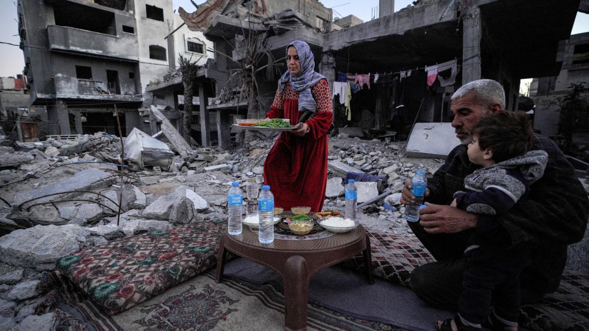 2 - having Ramadan iftar (dinner) on the ruins of their home.