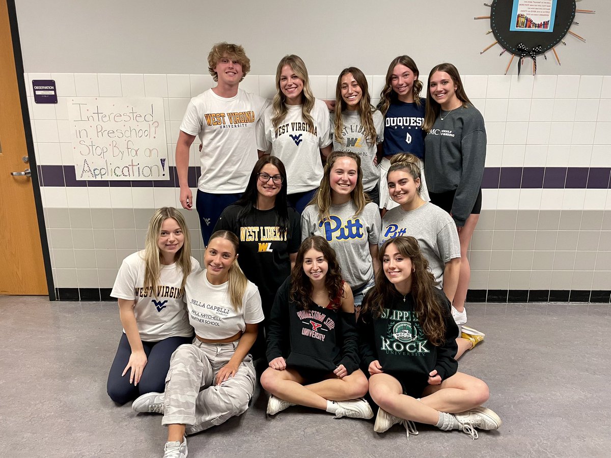 Preschool teachers show off their college decisions for Decision Day.