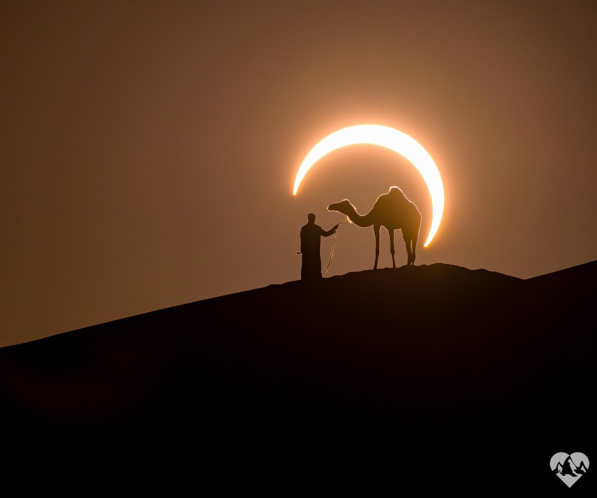 Perfectly Timed Photo Frames a Solar Eclipse Around a Man Leading a Camel in the Desert.

📸: Joshua Cripps
