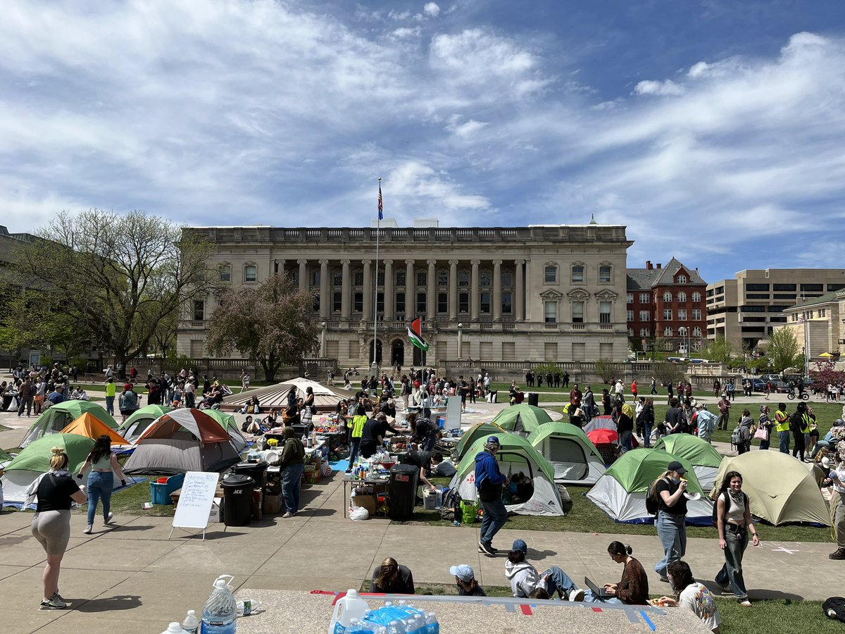 Tents @uwmadison were removed this morning but more than a dozen are now in place. Small number of visible law enforcement present. Schedule of events posted (rally, meeting, music).