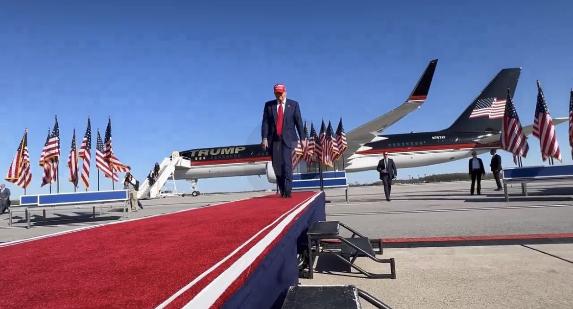 When you can’t afford to rent a venue, you have the rally on a tarmac.