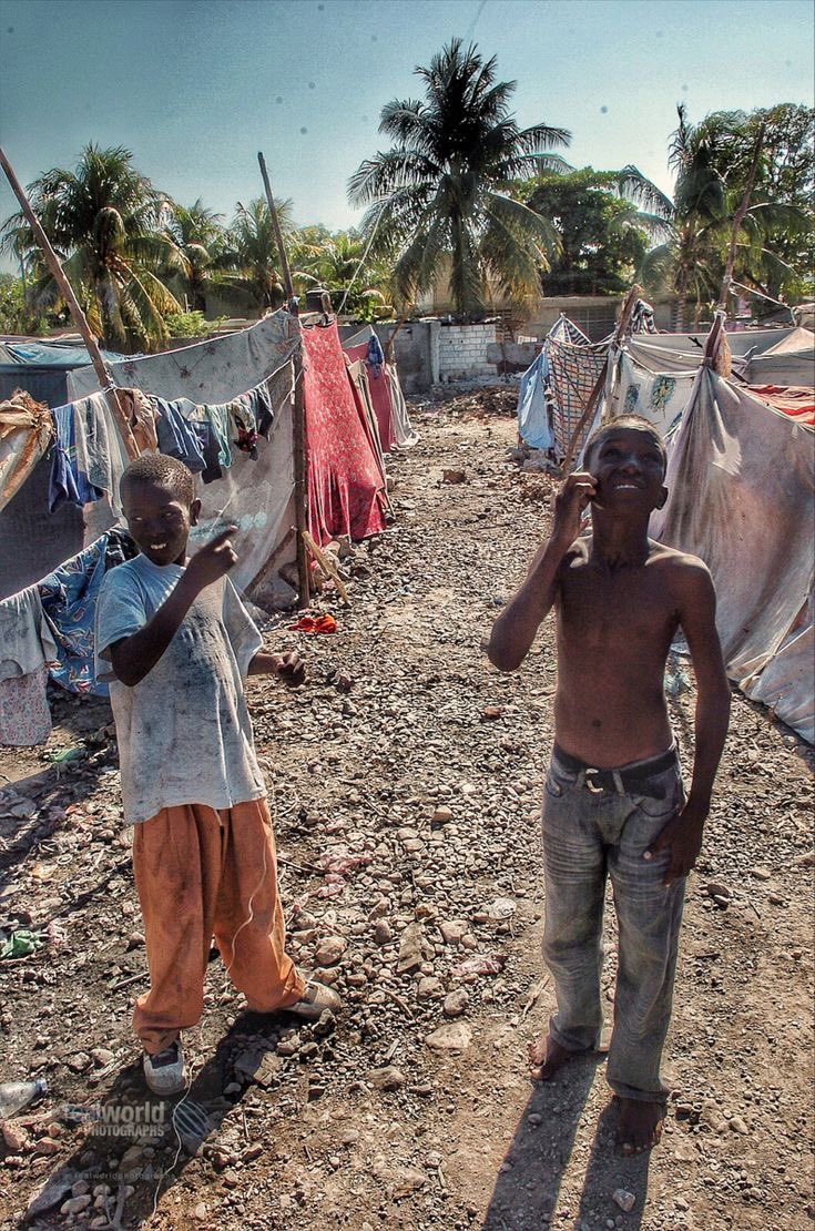 Two boys in a squalid, makeshift camp in Bon Repos, Haiti. 2010. Gary Moore photo. Real World Photographs. #world #poverty #haiti #photojournalism #haiti #sweden #malmo #garymoorephotography #realworldphotographs #nikon