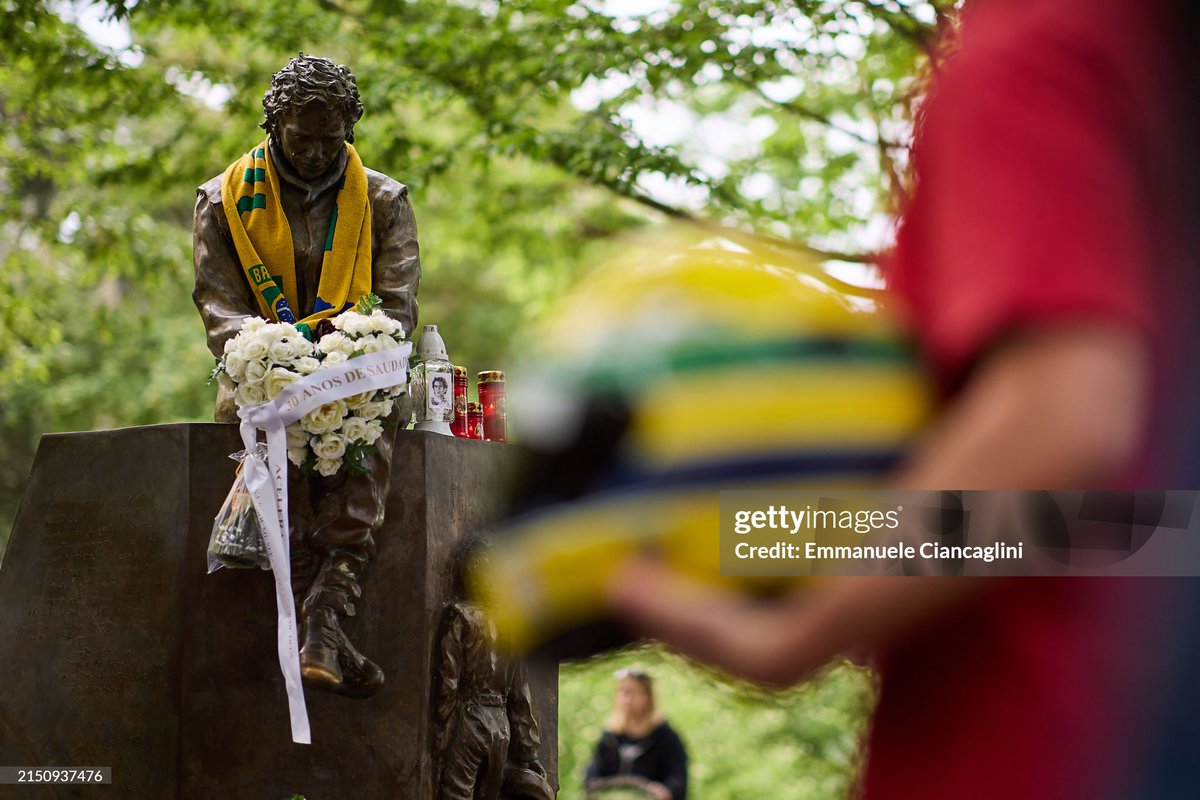 People visit the monument dedicated to Brazilian F1 legend Ayrton Senna during an event to commemorate the 30th anniversary of his death on May 1st in Imola, Italy. Senna, and Austrian driver Roland Ratzenberger, at just his third F1 race, both died on the same weekend in crashes…