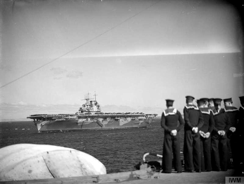 Being watched by ratings on HMS Illustrious (87), USS Wasp (CV-7) comes to anchor at Scapa Flow Anchorage in May 1942.