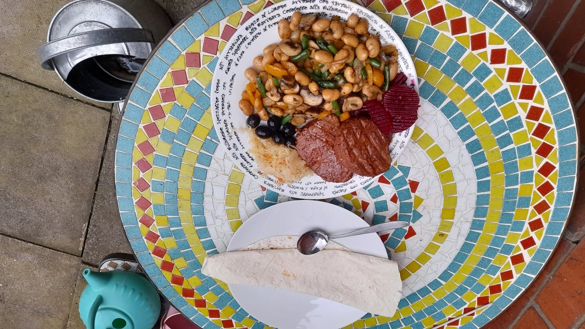 Lovely tea in the back garden, butterbean casserole, sauerkraut, reduced price Veggie burgers, black olives, beetroot and a piece of Lavash bread, cost around 90p to make.