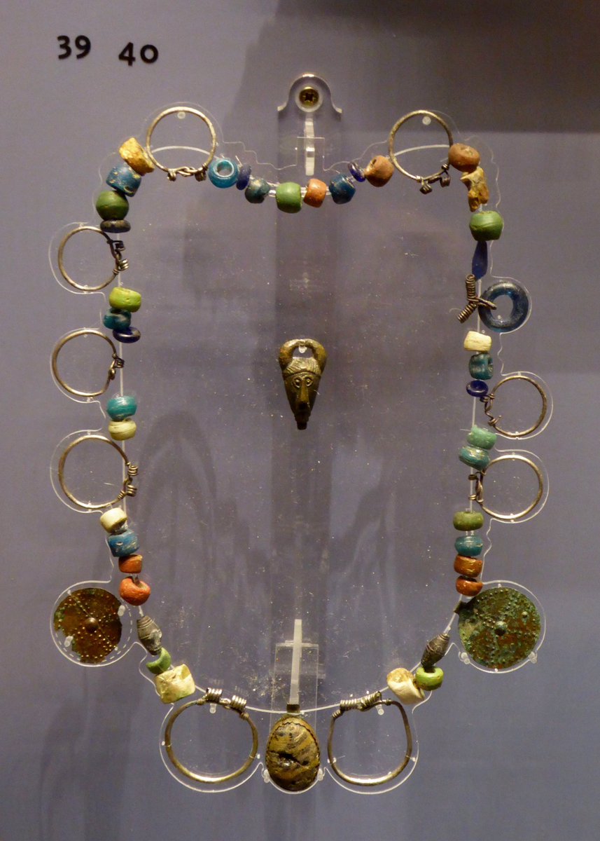 An early Anglo Saxon necklace from the burial ground in Finglesham, Kent, featuring two sun crosses and a horned Woden pendant.