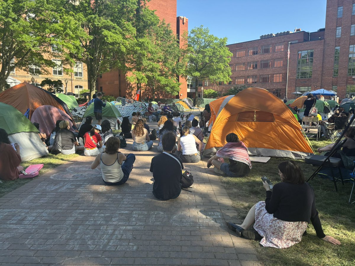 One student inside the GWU encampment calls for “an end to the US empire… and Israeli occupation” during a speech. He’s met with applause from the crowd.