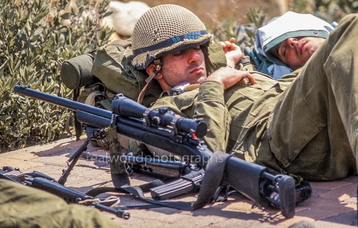 Israeli soldiers take a nap with their weapons nearby outside Jerusalem. 2002. Gary Moore photo. Real World Photographs. #israel #palestine #soldiers #idf #war #conflict #garymoorephotography #realworldphotographs #nikon #photojournalism #sony #newsphotography #photography