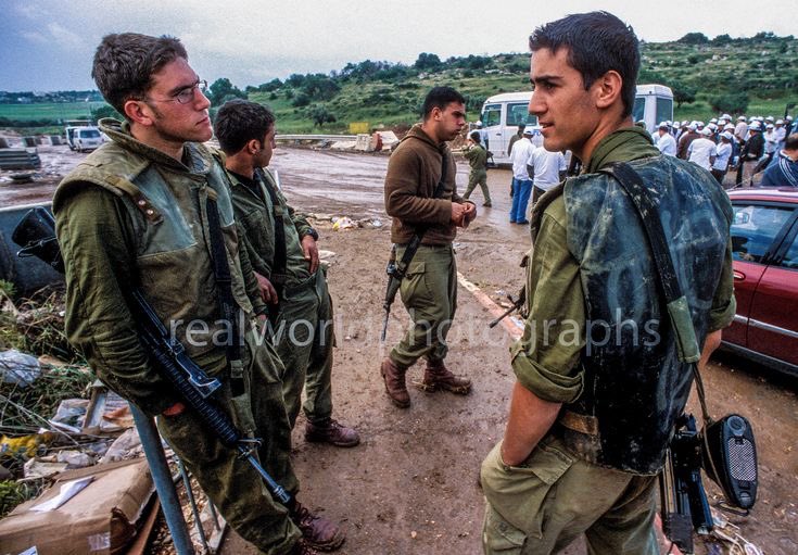 Young Israeli soldiers at a roadblock outside Jenin, West Bank, Palestine. 2002. Gary Moore photo. Real World Photographs. #israel #military #soldiers #idf #palestine #war #conflict #photography #garymoorephotography #realworldphotographs #nikon #photojournalism