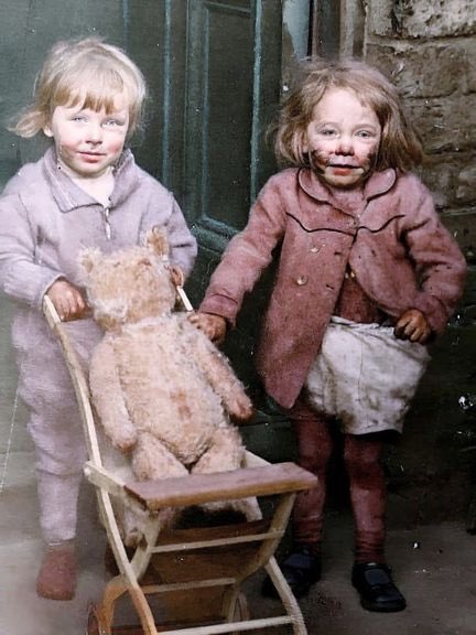 Two little girls and their teddy bear during the May blitz on Liverpool, 1941.