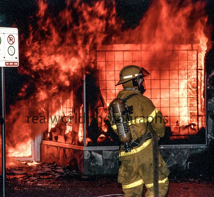 A firefighter waits for water to battle an arson fire in Kelowna, BC, Canada. 1995. Gary Moore photo. Real World Photographs. #firefighter #canada #crime #britishcolumbia #kelowna #sweden #malmo #photography #garymoorephotography #realworldphotographs #nikon #photojournalism