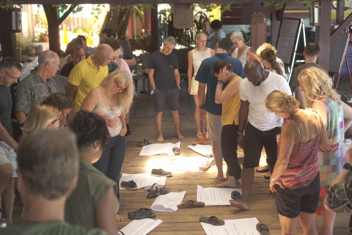 About half of us are gathered in Grenada this week to connect and grow together. 

Over the years we've posted a lot of photos of us looking at each other's sensemaking notes when we gather, but this is the first time those notes have been anchored by flip flops!