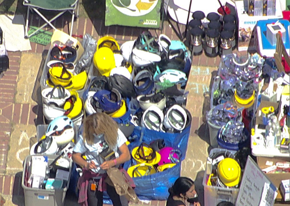 BREAKING: A disconcerting sight over the heavily vandalized Royce Hall quad, where the pro-Palestinian encampment at UCLA has been re-fortified. Organizers have brought in a large fresh supply of PPE, helmets, gas masks, goggles, umbrellas, paint, plywood, and other riot gear.…