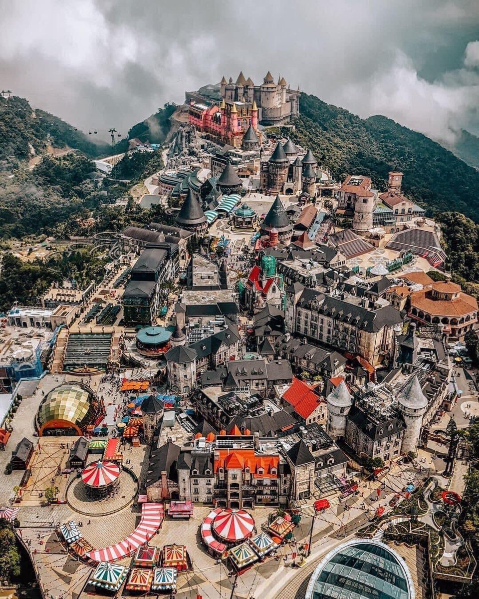 Apparently this is not photoshopped: a resort/entertainment complex developed by Vietnam’s Sun Group on Ba Na hills near Danang. 
It’s called a “French Village”. I have not seen anything like this in France 😱