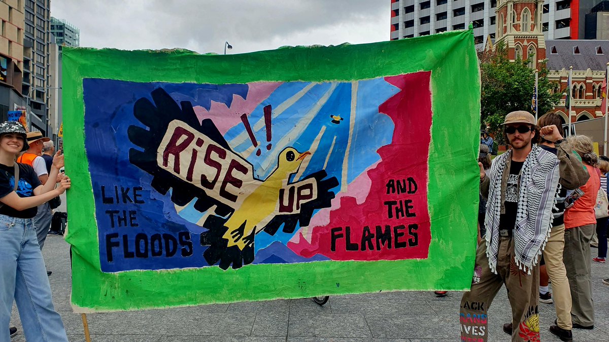 A beautiful banner from 350.org Magandjin drawing in the crowds at King George Square. Like the floods and flames we will #RiseUp to stop fossil fuels.