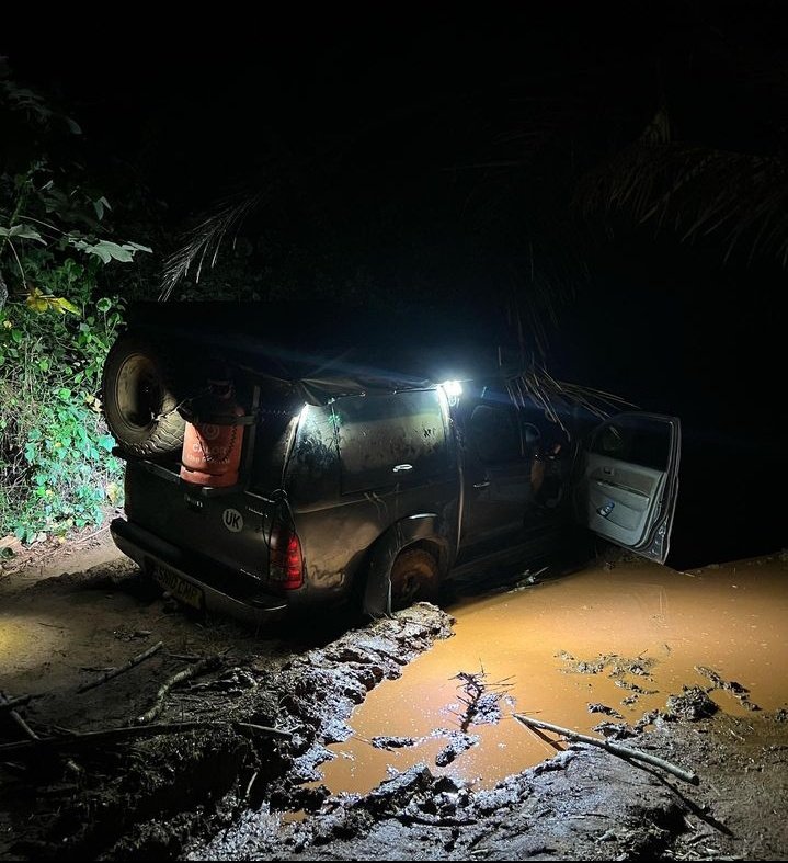 The car now stuck deep in the mud in Ivory Coast 😭