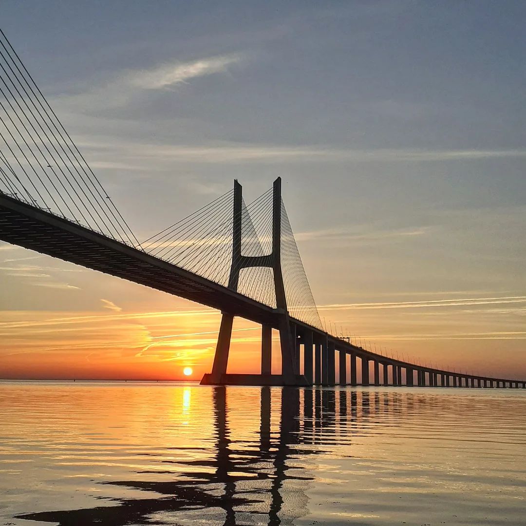 When the sun starts to edge its way over the horizon, the best place to be is by the Tagus river. 🤩 #VisitLisboa visitlisboa.com 📍 Parque das Nações 📷 @inezita_ig