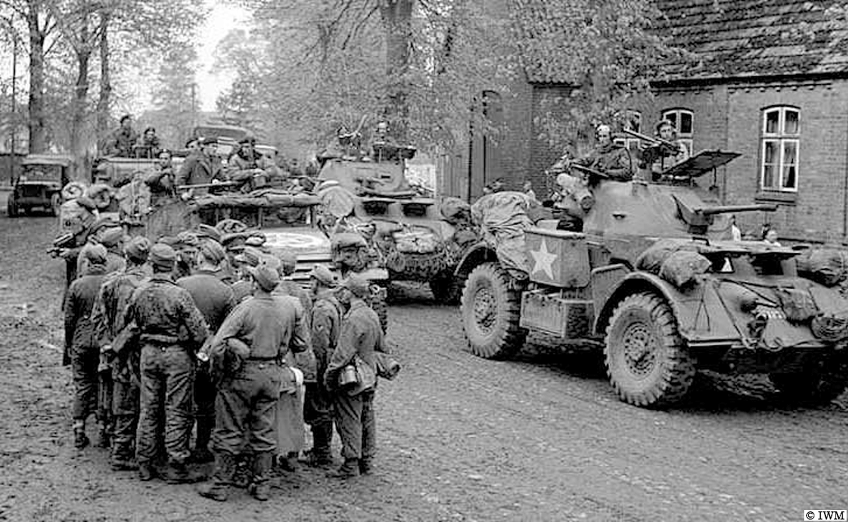 #OTD in 1945, Gudow, Germany. Staghound armoured cars and a White M3 scout car passing German POWs. #WW2 #HISTORY