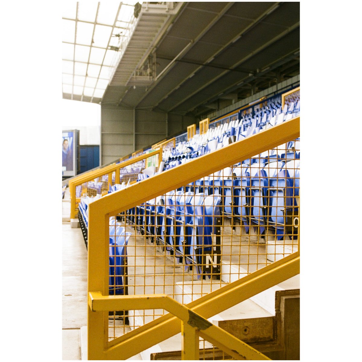 There’s something hypnotic to me about the empty seats at Goodison before the gates open. The identikit nature of those pieces of plastic and metal (and wood) yet each is the site of a unique-but-shared experience of watching the game. These are taken at each side of Goodison.