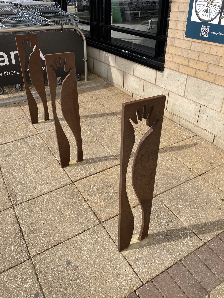 New bike racks at local M&S. The old ones were perfectly serviceable Sheffield Stands. These new ones need a sign to explain them to people wanting to park their bikes.