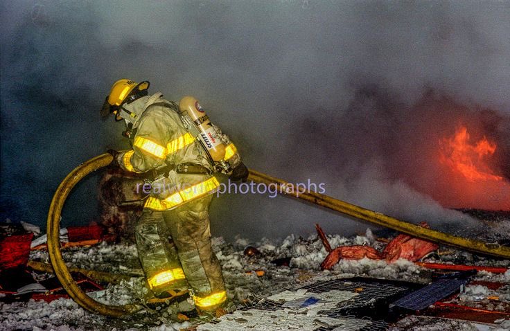A firefighter makes his way through the remains of a house fire in British Columbia, Canada. 1996. Gary Moore photo. Real World Photographs. #firefighter #explosion #canada #britishcolumbia #garymoorephotography #realworldphotographs #newsphotography #photography #photojournalism