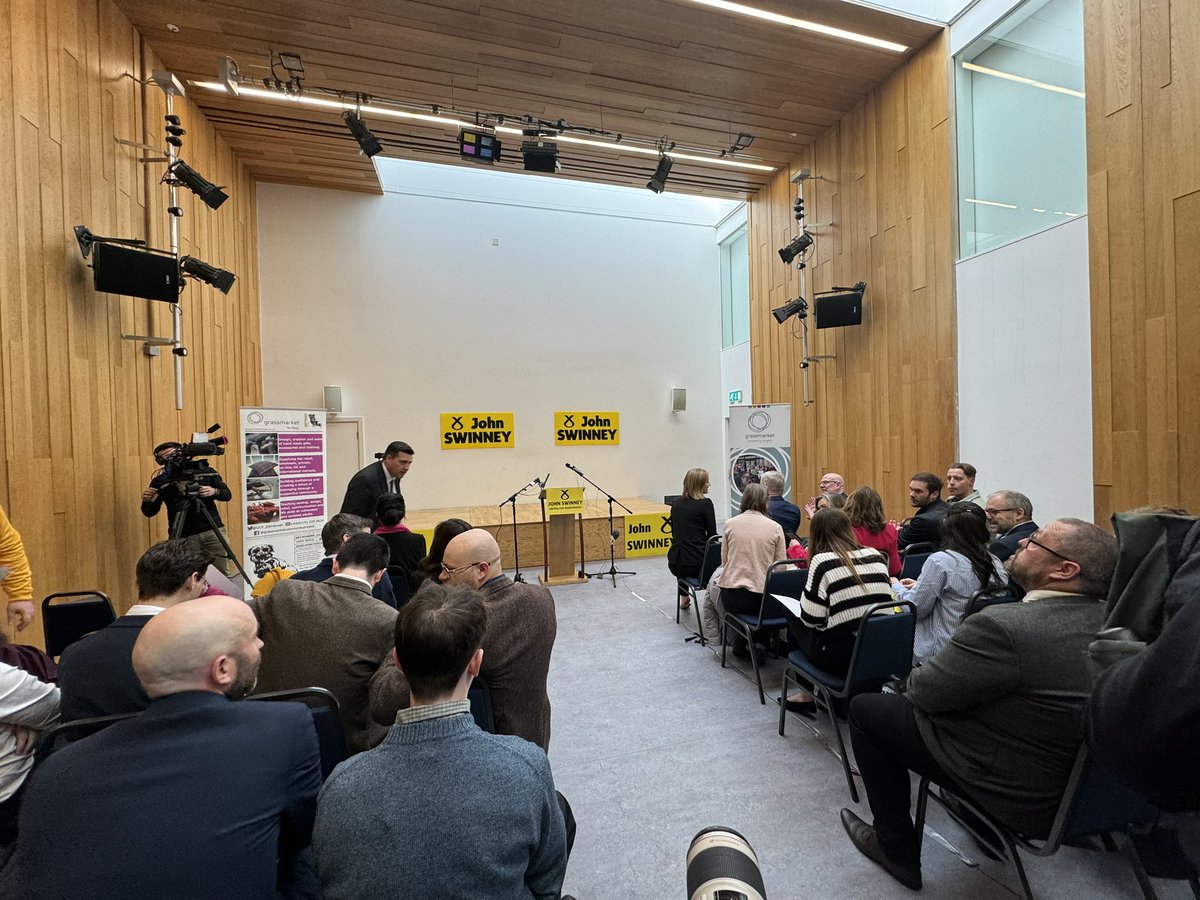 Scene inside the room where John Swinney will declare he is entering the race to become SNP leader. Front rows packed with current cabinet ministers. @SkyNews