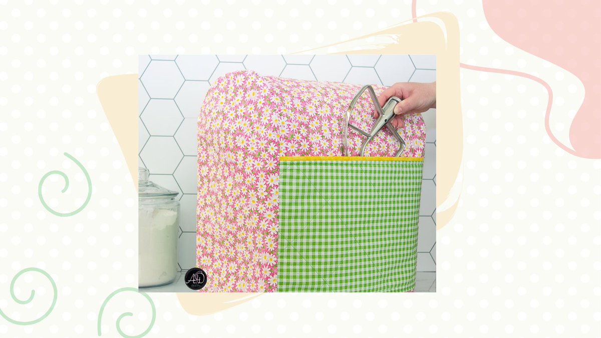 Nothing says spring like a field of pink and white flowers! This quilted mixer cover is the perfect accessory for your kitchen decor, AND it’s convenient! #springkitchendecor #andegdesign #quiltedhandmadedecor #charmingkitchendecor #standmixercover  #handmadewallhangings