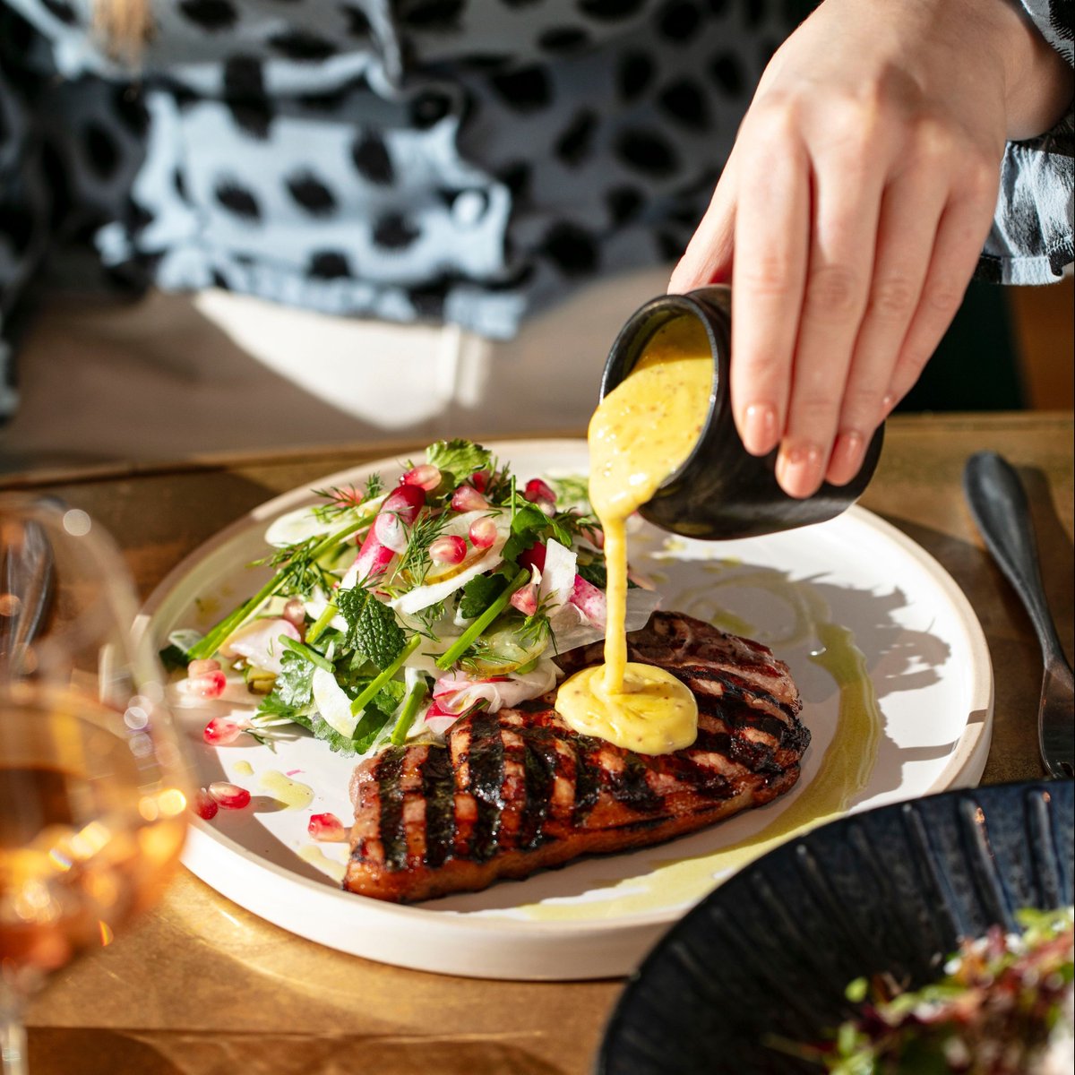Our bacon chop with radish, celeriac, fennel and cornichon salad with mustard cream.