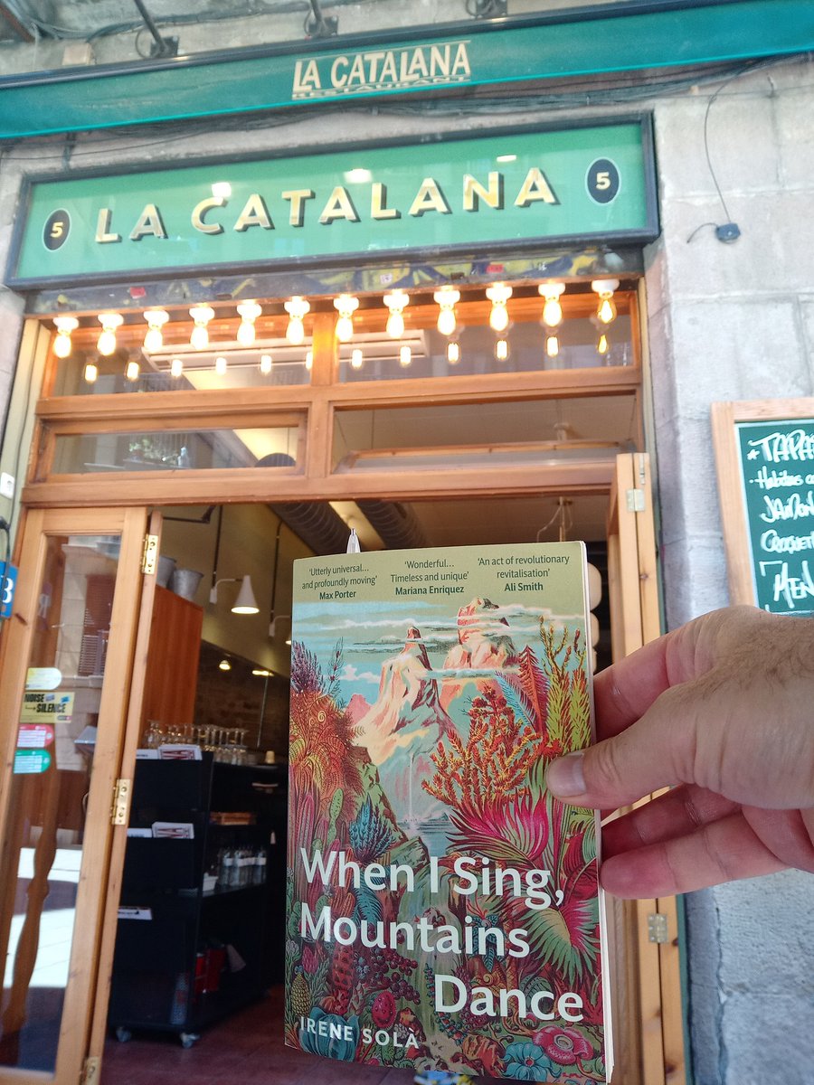 I couldn't resist the temptation today when we had lunch here, to take a picture of my current read. #IreneSolà's When I Sing, Mountains Dance translated from Catalan by #MaraFayeLethem A wonderful polyphonic novel set in the Pyrenees. #CatalanLiterature #Barcelona #LaCatalana