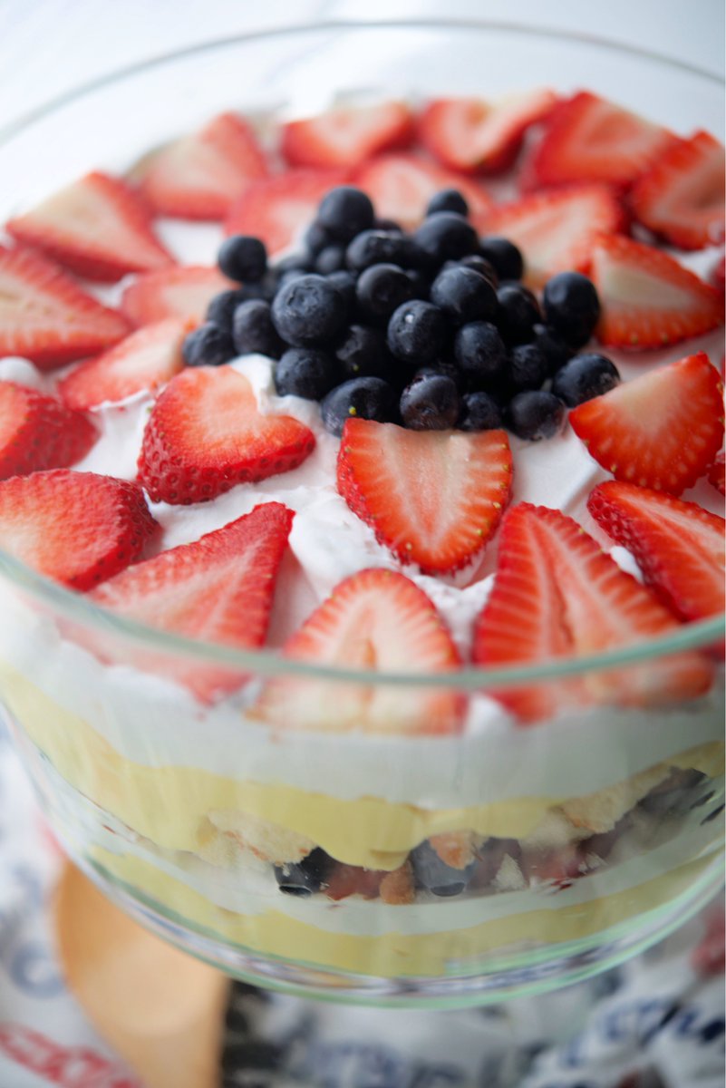 This no bake Patriotic Berry Trifle made with butter poundcake, vanilla pudding, whipped topping, fresh strawberries and blueberries is perfect for those Summer holiday gatherings. RECIPE--> carriesexperimentalkitchen.com/patriotic-berr… #desserts #trifle