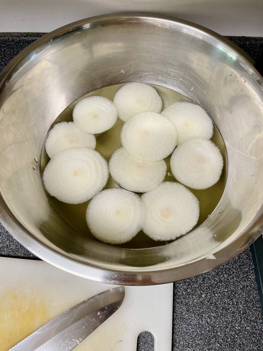 10 Vidalia Onions:
•Tops + scraps are simmering for onion broth
•Halved and sliced the middle for dehydrating
•Soaking the ass end in water. When it cools off for the day I will stick them under the hay in my tomato pots to see if any want to grow
