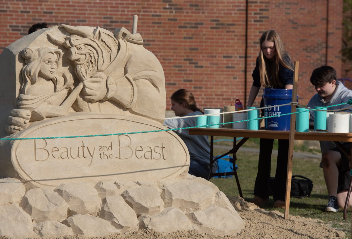 Students Logan Broadway, right, and Ella Keefe, second from right, work on their sand castles during a sand sculpture workshop put on by Sean Fitzpatrick from Saugus. He created a themed sculpture outside the Bourne High School. @capecodtimes