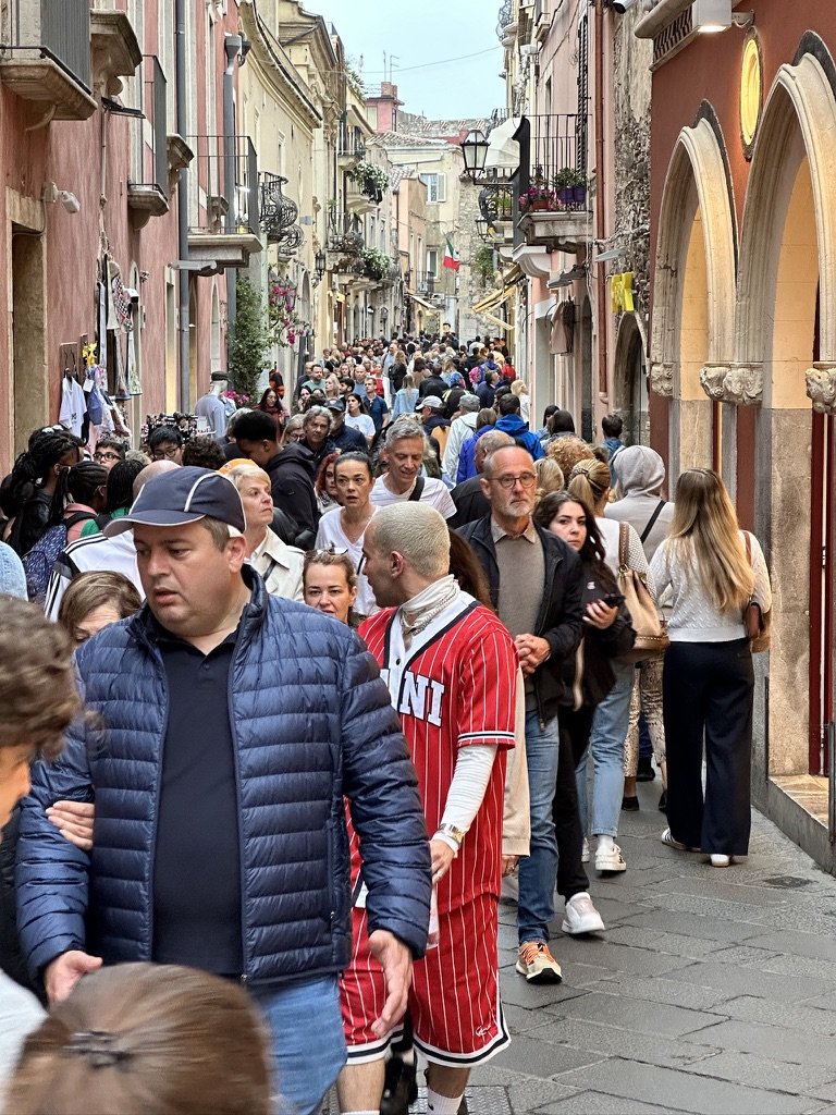 Meanwhile, in Taormina... Not a big fan of crowds... so at 6' 2', I've learned a trick: stare blankly forward about 1 foot over people's heads and 98% of people will move out of your way 🙂.