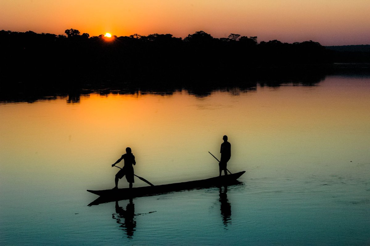 Immense but calm. The mighty Congo River flowing through Central African Republic as the sun sets (5:51pm today) mirrors two boys in a dugout canoe.