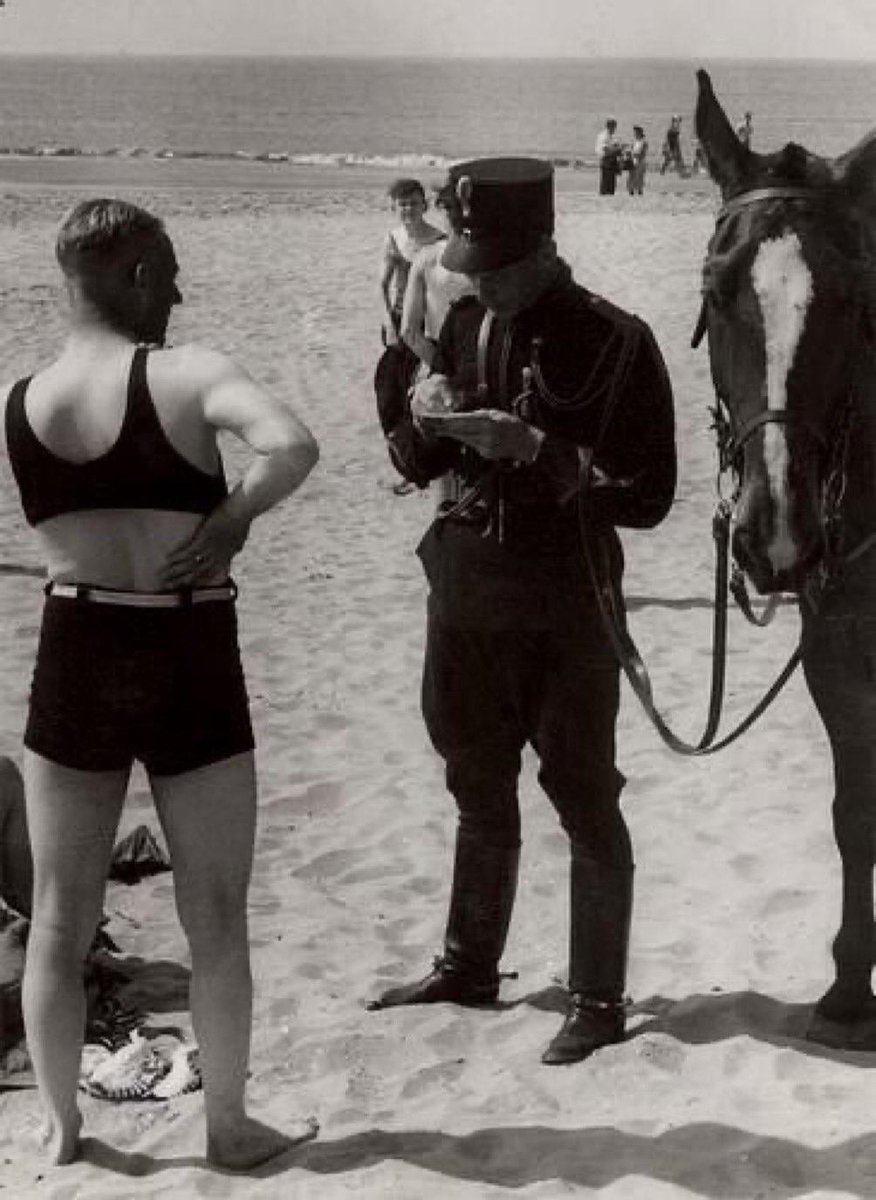 A man on the beach is fined for not wearing decent clothes in Netherlands, 1931.